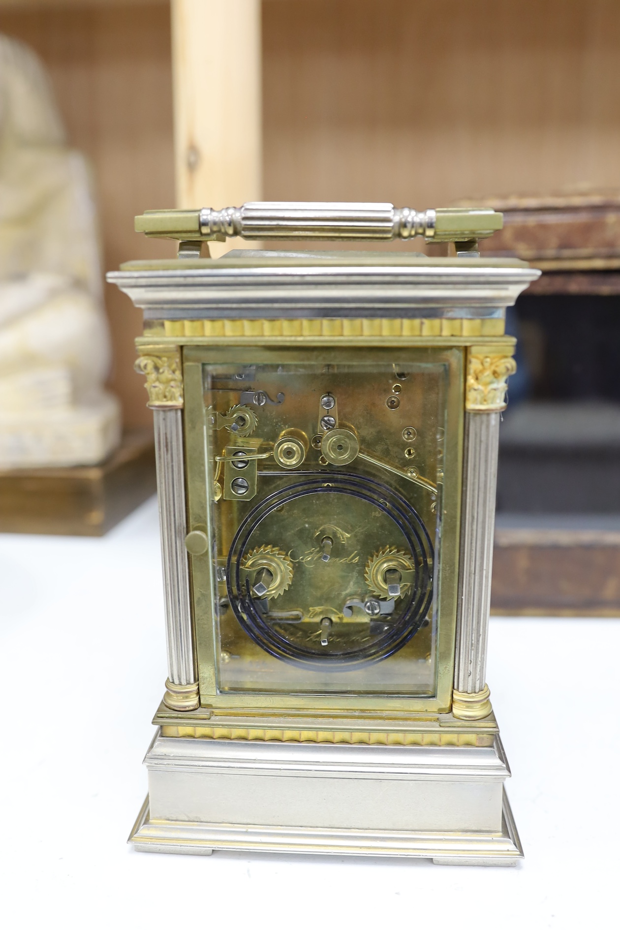 A carriage clock, in leather case, 18cm high. Condition - gilding worn and surface slightly pitted in places